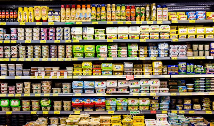 shelf-with-food-in-a-supermarket-milk-products-butter-E2JY6H