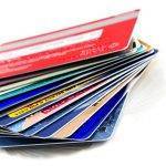 Stack of colorful credit cards with small reflection