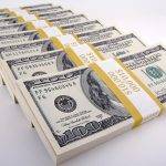 Row of Stacks of One Hundred Dollar Bills
