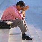 Businessman Thinking on Steps