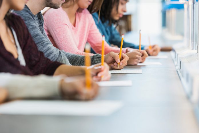 Cropped view of group of teenagers taking a testeducationedu