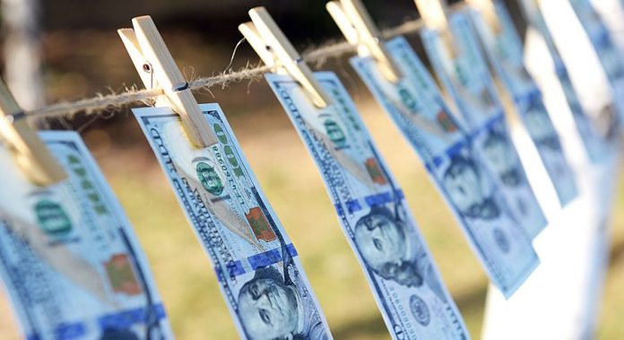 Concept of money laundering - one hundred bills hanging on a cor