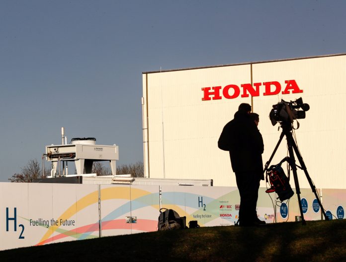 Members of media stand outside the Honda car plant in Swindon