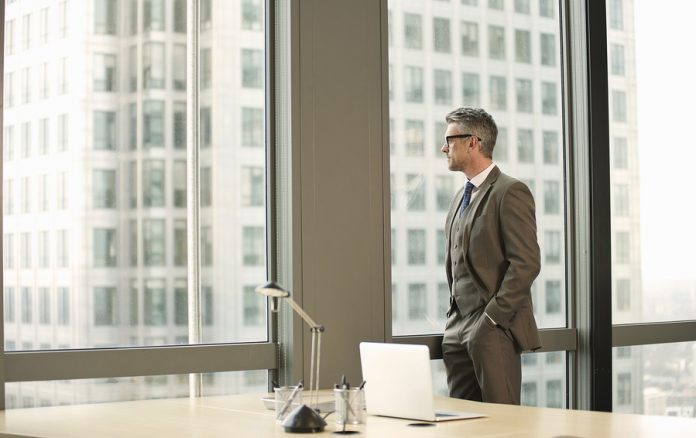 Businessman looking out of office window