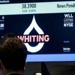 a-trader-waits-for-the-opening-of-whiting-petroleum-s-stock-at-the-post-where-it-is-traded-on-the-floor-of-the-new-york-stock-exchange-5